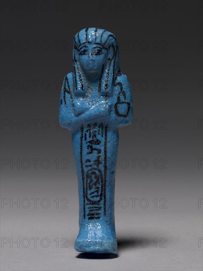 Shawabty of Pinudjem I, High Priest of Amen and King, c. 990-969 BC. Egypt, Thebes, Third Intermediate Period, early Dynasty 21. Bright blue faience with purple details; overall: 11 x 3.6 x 2.5 cm (4 5/16 x 1 7/16 x 1 in.).