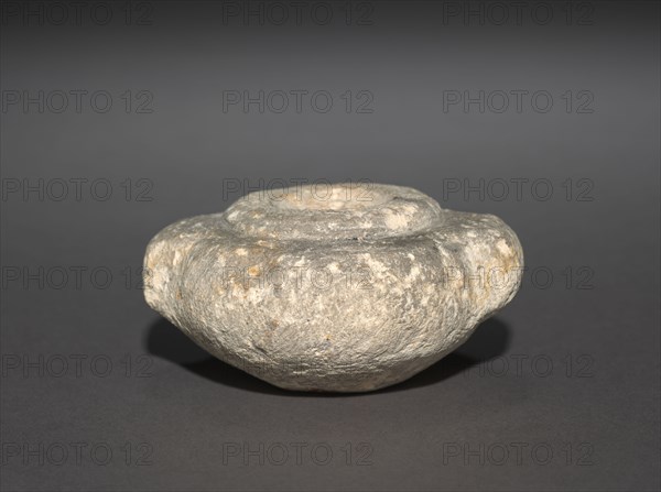 Squat Dummy Jar with Lug Handles, 2770-2573 BC. Egypt, Probably Saqqara, north of the Step Pyramid, excavations of J. E. Quibell, 1910-1911, Predynastic, Dynasties 2-3, 2770-2573 BC. Sandstone; diameter: 7.4 cm (2 15/16 in.); diameter of mouth: 2.5 cm (1 in.); overall: 3.5 cm (1 3/8 in.).