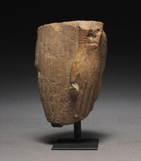 Fragment of a Feather-Garmented Figure, 1540-715 BC. Egypt, New Kingdom or Third Intermediate Period. Limestone; overall: 9 x 5.6 x 5.8 cm (3 9/16 x 2 3/16 x 2 5/16 in.).
