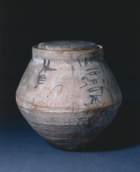 Shawabty Jar with Lid, 1295-1069 BC. Egypt, New Kingdom, Dynasty 19 (1295-1186 BC) - Dynasty 20 (1186-1069 BC). Nile silt ware; lid of limestone; diameter: 22.7 cm (8 15/16 in.); overall: 23.2 cm (9 1/8 in.); diameter of lid: 12.1 cm (4 3/4 in.).