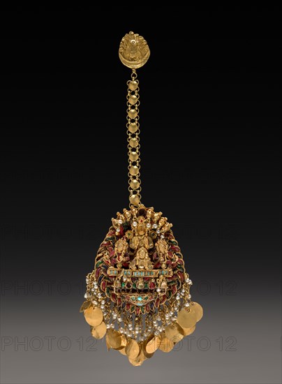 Forehead Pendant with Sun God Surya in a Chariot with Attendants, 1600s or 1700s. Nepal, Kathmandu Valley. Gold set with jewels and semi-precious stones; overall: 8 x 4.6 cm (3 1/8 x 1 13/16 in.).