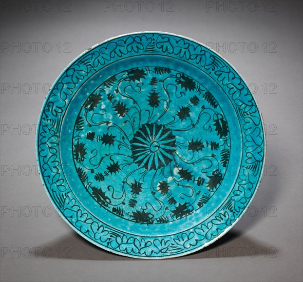 Dish, c. 1600. Caucasus or northern Iran. Fritware with underglaze-painted design in black slip ("Kubachi" ware); diameter: 34.2 cm (13 7/16 in.).