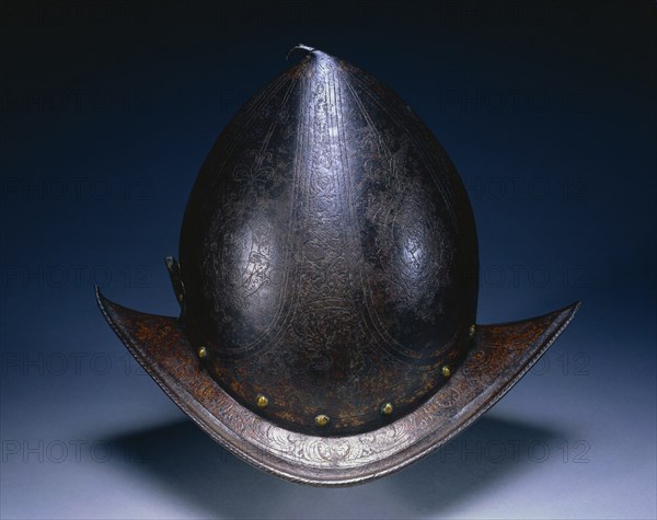 Peaked Morion, c. 1580-1590. North Italy, Milan?, 16th century. Etched russet steel with traces of gilding; roped brim, brass plume holder; overall: 35.4 x 23.7 x 26.7 cm (13 15/16 x 9 5/16 x 10 1/2 in.).