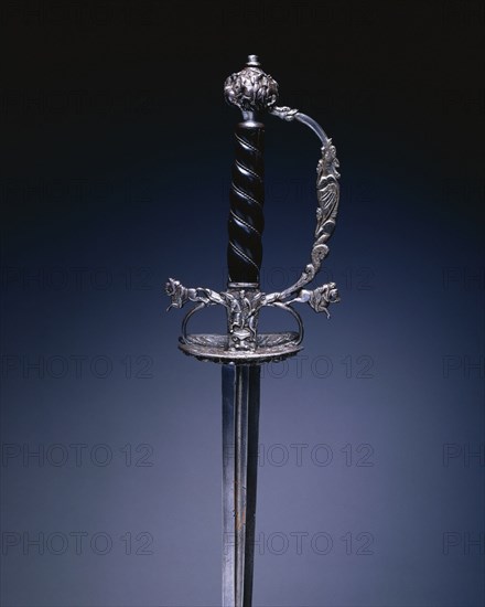 Small Sword, 1640-1660. Germany, Passau (?), 17th century. Steel, wood, steel wire, copper, chiseled shell guard; blade: blued, gilded, pierced and engraved; overall: 104.5 cm (41 1/8 in.); blade: 86 cm (33 7/8 in.); guard: 7.6 cm (3 in.).