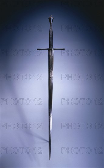 Hand-and-a-Half Sword, c. 1550. Germany, mid-16th century. Steel, blued pommel and quillions, leather grip; overall: 123.9 cm (48 3/4 in.); blade: 92.3 cm (36 5/16 in.); quillions: 24.8 cm (9 3/4 in.); grip: 30.5 cm (12 in.)