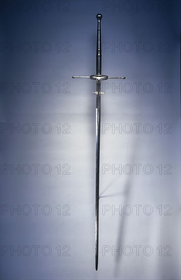 Two-Handed Sword, 1550-1600. Spain, Toledo, second half of 16th Century. Steel, wood and leather grip; fluted pommel; overall: 168.3 cm (66 1/4 in.); blade: 126.4 cm (49 3/4 in.); quillions: 35.2 cm (13 7/8 in.); grip: 41.3 cm (16 1/4 in.); ricasso: 20.3 cm (8 in.).
