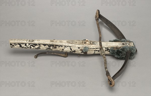 Crossbow of Elector Augustus I of Saxony, c. 1553-1573. Germany, Saxony, 16th century. Wood (walnut?), bone veneers, flax cord, steel (etched, traces of gilding). woolen pompoms, stock decorated wih inlaid trophies of arms; overall: 58.5 cm (23 1/16 in.); bow: 58.5 cm (23 1/16 in.); butt: 5.7 cm (2 1/4 in.).