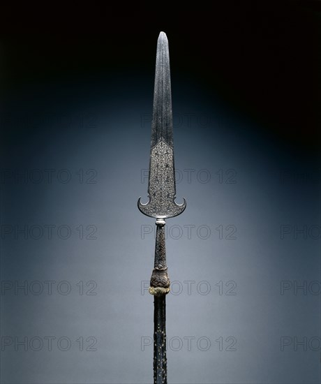 Partisan, c. 1600-1650. France, 17th century. Steel, etched; octagonal wood haft with studs and leather; remnants of velvet tassel; overall: 217.2 cm (85 1/2 in.); blade: 57.2 cm (22 1/2 in.).