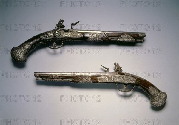 Pair of Flintlock Pistols, c. 1670. Italy, Brescia, 17th century. Steel, chiseled decoration with walnut stock; overall: 45.1 cm (17 3/4 in.); barrel: 27.6 cm (10 7/8 in.); bore: 1.3 cm (1/2 in.).