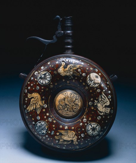 Powder Flask, c. 1620-1650. Germany, 17th century. Walnut inlaid with ivory decoration; turned steel funnel with spring cap; diameter: 12.1 cm (4 3/4 in.); overall: 17.2 cm (6 3/4 in.).