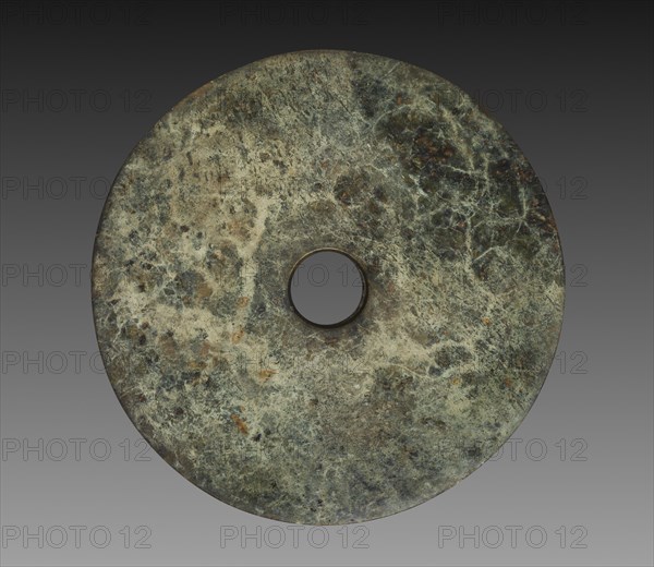 Ceremonial Disk (Bi), 3300-2200 BC. East China, Neolithic period, Liangzhu culture (3300-2200 BC). Jade (nephrite); diameter: 32 cm (12 5/8 in.); overall: 1 cm (3/8 in.); inner diameter: 5.4 cm (2 1/8 in.).