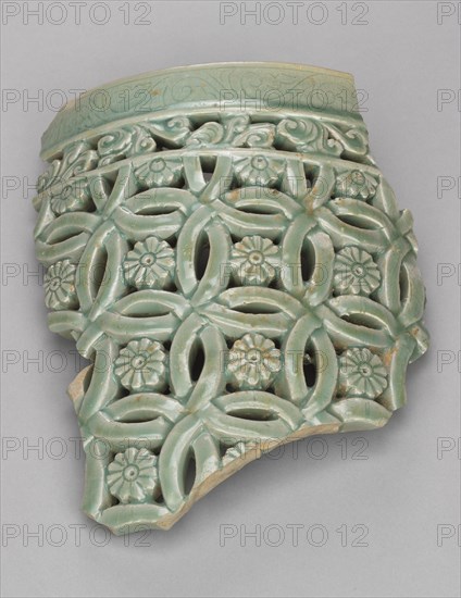Fragment of Garden Stool with Openwork Design, 1200s. Korea, Goryeo period (918-1392). Stoneware with celadon glaze, insiced scroll design, and carved openwork pattern with floral centers; overall: 27.5 x 20.3 cm (10 13/16 x 8 in.).