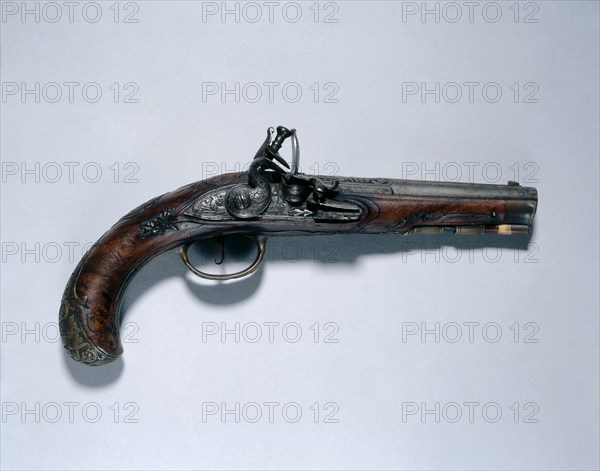 Flintlock Pistol, c. 1750. Johann Andreas Kuchenreuter (German, 1716-1795). Steel, walnut stock, brass mounts, barrel inlaid with gold, brass, and silver; overall: 25.7 cm (10 1/8 in.); barrel: 14.5 cm (5 11/16 in.); bore: 1.2 cm (1/2 in.).