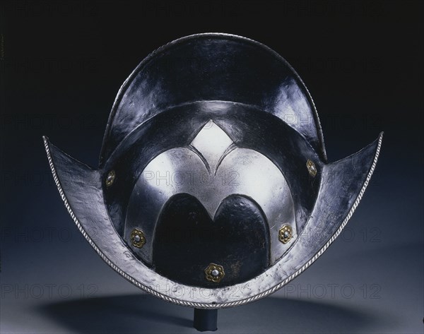 Black and White Morion (of Munich Town Guard), c. 1575-1600. Germany, late 16th Century. Steel, roped edge, decorative brass rivet washers as rosettes; black paint; overall: 25.4 x 36.2 x 23.2 cm (10 x 14 1/4 x 9 1/8 in.).