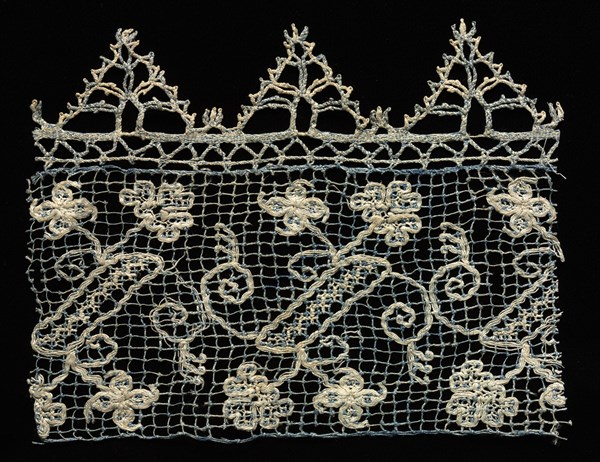 Fragment of a Border with Vines and Floral Motifs, 1600s. Italy, 17th century. Needle lace, filet/lacis (knotted ground and darned in one direction) and bobbin lace edging; bleached and blue dyed linen (est.); overall: 13.5 x 17.4 cm (5 5/16 x 6 7/8 in.)