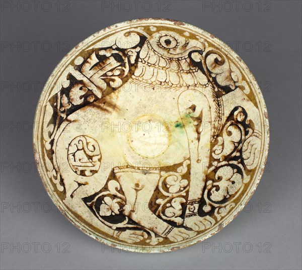 Bowl with Griffin, 1100s. Northwest Iran, Garrus district, Seljuk period, 12th century. Earthenware with underglaze slip-painted decoration; overall: 6.6 x 16.7 cm (2 5/8 x 6 9/16 in.).