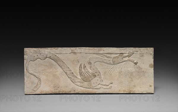 Relief with Dragon from a Funerary Stove Model, 206 BC - AD 220. China, from a tomb in Sian-fu, Shensi province, Han dynasty (202 BC-AD 220). Earthenware with relief decoration; overall: 10.2 x 27.4 cm (4 x 10 13/16 in.).