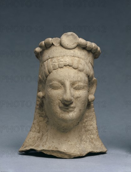 Woman's Head with Crown and Earrings, 600-475 BC. Greece, Sicily (?), 6th Century BC, or early 5th Century. Terracotta; overall: 15.2 cm (6 in.).