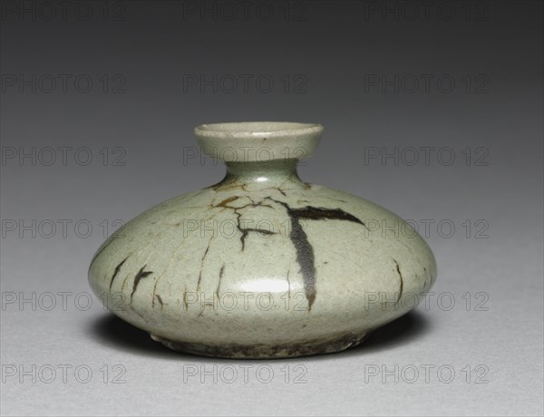 Oil Bottle, 1100s-1200s. Korea, Goryeo period (918-1392). Celadon ware; outer diameter: 7.4 cm (2 15/16 in.); overall: 4.6 cm (1 13/16 in.).