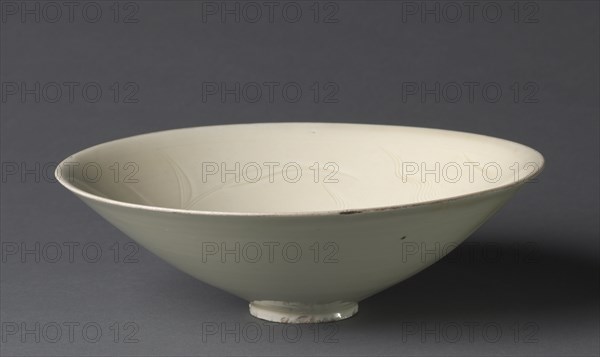 Bowl with Ducks among Waves and Reeds, 1100s. China, Hebei province, Quyang, Northern Song dynasty (960-1127). Cream-glazed porcelain with incised decoration, Ding ware ; diameter: 20.3 cm (8 in.); overall: 5.4 cm (2 1/8 in.).
