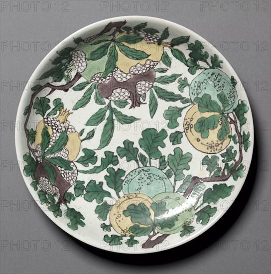 Dish with Dragons, Pomegranates, and Peaches, 1662-1722. China, Jiangxi province, Jingdezhen, Qing dynasty (1644-1911), Kangxi mark and period (1662-1722). Porcelain with incised and enamel decoration, susancai ware; diameter: 24.8 cm (9 3/4 in.).