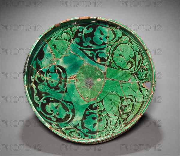 Bowl, 1100s-1200s. Northwest Iran, Garrus district, late Saljuq Period, 12th-13th Century with 20th Century replacement fragments. Earthenware with underglaze slip-painted decoration;