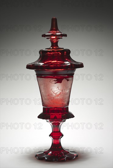 Covered Cup, mid-1800s. Bohemia, 19th century. Ruby glass with engraved decoration; diameter: 36.5 x 17.5 cm (14 3/8 x 6 7/8 in.); overall: 59 cm (23 1/4 in.).