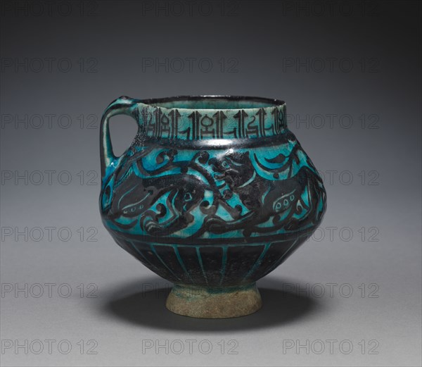 Jug with Running Animals, 1150-1220. Iran, probably Kashan, Seljuk Period, 12th-13th Century. Fritware with design in carved and underglaze-painted slip ("silhouette" ware); overall: 13 x 14 cm (5 1/8 x 5 1/2 in.); diameter of rim: 8.9 cm (3 1/2 in.).