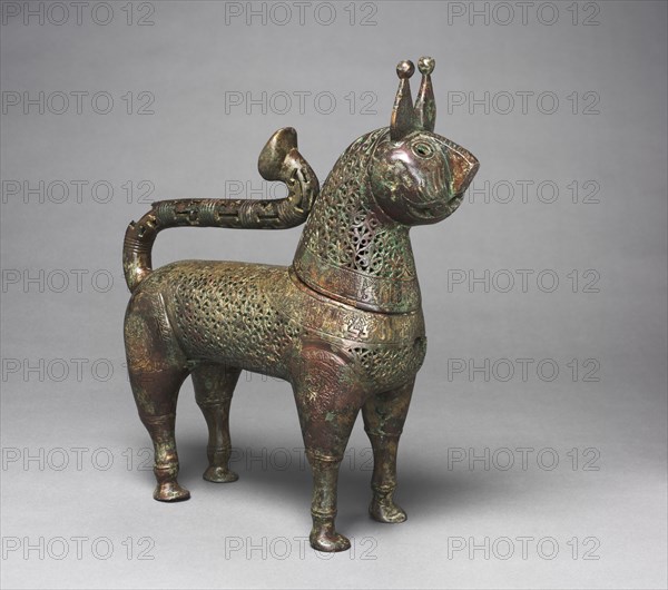 Feline incense burner, 1100s. Eastern Iran, western Afghanistan, or Turkmenistan, Khorasan. Copper alloy, cast and chased; overall: 35.5 x 11 x 32.5 cm (14 x 4 5/16 x 12 13/16 in.); head: 17.8 x 9.5 x 12.5 cm (7 x 3 3/4 x 4 15/16 in.).