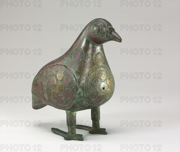Bird-shaped Vessel, 1100s. Iran, Seljuk Period, 12th Century. Bronze, cast, with chased and chiseled decoration; eyes inlaid with blue glass; overall: 17.5 x 9.5 cm (6 7/8 x 3 3/4 in.).