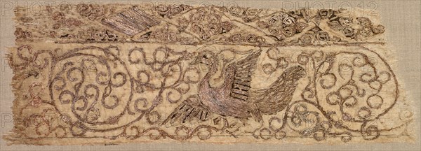 Embroidered fragment with bird among vines, 1100s. Iraq, Baghdad, Seljuq period. Plain weave: silk warp and cotton weft (mulham); embroidery, couched and split stitches: silk and metallic thread; overall: 7.3 x 21.6 cm (2 7/8 x 8 1/2 in.)