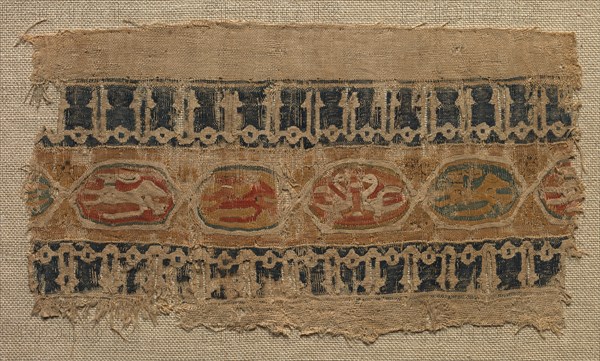 Fragment of a Tiraz-Style Textile, 1081 - 1094. Egypt, Fatimid period, Caliphate of al-Mustansir, c. AH 475-487 (A.D. 1081-1094). Tabby ground with inwoven tapestry ornament; linen and silk; overall: 10.5 x 18.5 cm (4 1/8 x 7 5/16 in.).