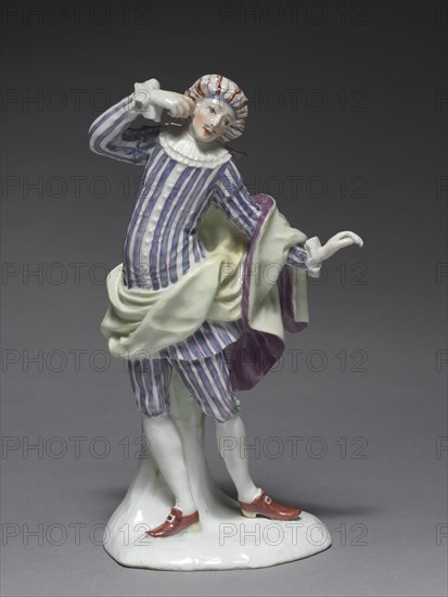 Italian Comedy Figure: Mezetin, c. 1753. Fürstenberg Porcelain Factory (German), Simon Feilner (German, 1798). Porcelain with enamel decoration; overall: 19.7 x 9.4 x 8.1 cm (7 3/4 x 3 11/16 x 3 3/16 in.).