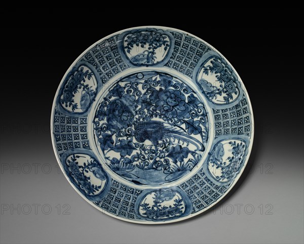 Plate with Phoenix and Peonies:  Swatow Ware, late 1500s-early 1600s. China, Southern Fujian province, Ming dynasty (1368-1644). Porcelain with underglaze blue decoration; diameter: 47.3 cm (18 5/8 in.); overall: 9.7 cm (3 13/16 in.).