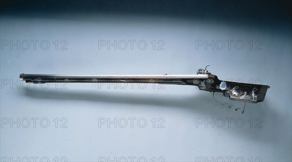 Wheel-Lock Hunting Rifle, mid 17th century. Hans Schmidt (Austrian, 1669). Steel, varnished wood (walnut) stock decorated with inlaid silver wire and appliqués; overall: 110.2 cm (43 3/8 in.); butt: 8.6 cm (3 3/8 in.); barrel: 83.2 cm (32 3/4 in.); bore: 1.3 cm (1/2 in.).
