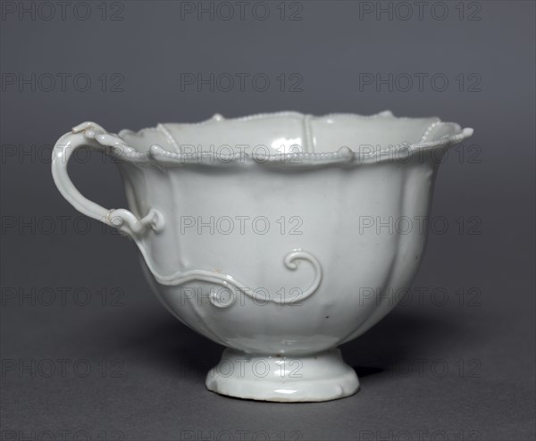 Fluted Cup with Dragon Handle, Qingbai Ware, early 14th Century. China, Jiangxi province, Jingdezhen kilns, Yuan dynasty (1271-1368). Glazed porcelain; diameter: 9 cm (3 9/16 in.); overall: 6 cm (2 3/8 in.).