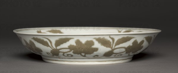Dish with Flowers and Fruit, 1488-1505. China, Jiangxi province, Jingdezhen kilns, Ming dynasty (1368-1644), Hongzhi mark and reign (1488-1505). Porcelain with incised and underglaze coffee brown (iron oxide) decoration; diameter: 25.8 cm (10 3/16 in.); overall: 26 cm (10 1/4 in.).