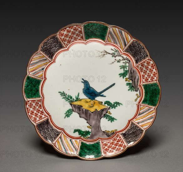 One of a Pair of Dishes with Singing Bird on a Rock: In Ko Kutani Style, 18th century. Japan, Edo Period (1615-1868). Porcelain with underglaze blue and overglaze enamel decoration; diameter: 20.8 cm (8 3/16 in.); overall: 3.3 cm (1 5/16 in.).