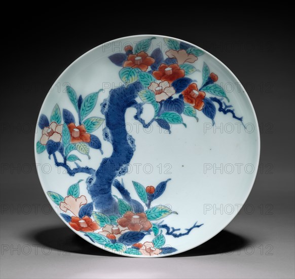 Dish with Branch of Camellia, c. 1688–1716. Japan, Edo period (1615-1868). Porcelain with underglaze blue and overglaze color enamel (Hizen ware, Nabeshima type); diameter: 20.2 cm (7 15/16 in.); overall: 5.8 cm (2 5/16 in.).