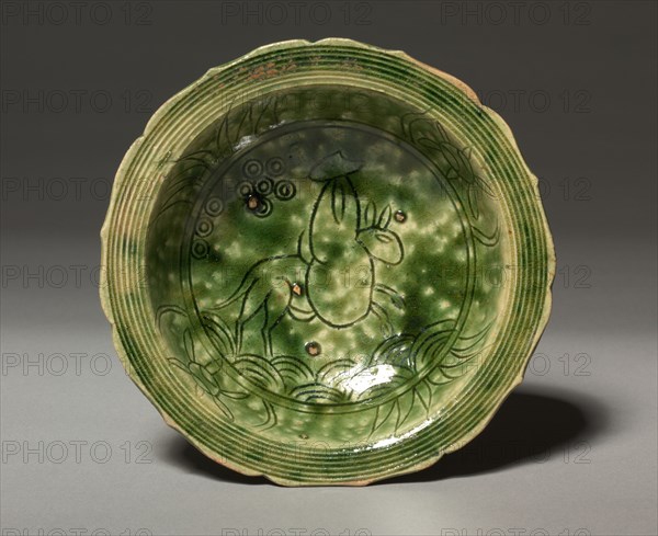 Dish with Incised Design of a Rider on a Mule:  Oribe Ware, c. 1600. Japan, Gifu Prefecture, Mino kilns, Momoyama period, 1573-1615. Buff stoneware covered with copper-green glaze; diameter: 16.7 cm (6 9/16 in.).