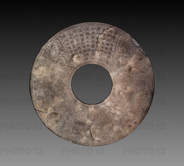 Disc (bi) with Imperial Poem in Seal Script (zhuanshu) by the Qianlong Emperor, 1736-95. China, Qing Dynasty (1644-1911), Qianlong reign (1736-95). White jade with brown mottling, historic jade, recut and incised; diameter: 11.4 cm (4 1/2 in.).