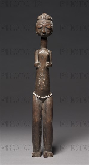 Female Figure, late 1800s-early 1900s. Guinea Coast, Ivory Coast, late 19th to early 20th century. Wood, metal; overall: 54.1 x 7.8 x 7.5 cm (21 5/16 x 3 1/16 x 2 15/16 in.)