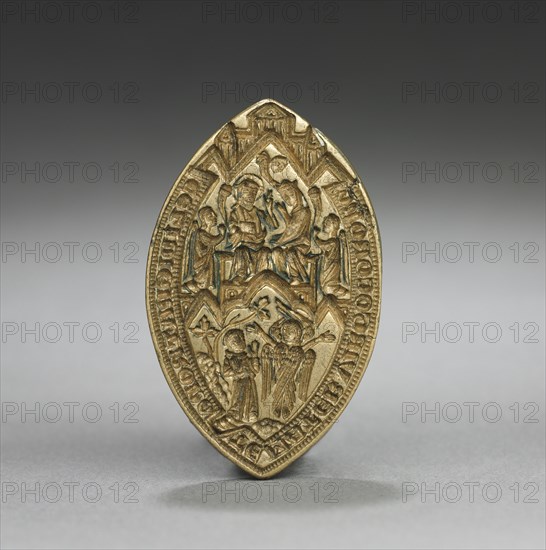 Almond-Shaped Seal: Coronation of the Virgin with a Kneeling Monk, 1300s. England or Germany, Gothic period, 14th century. Gilded bronze; overall: 3.9 x 2.6 cm (1 9/16 x 1 in.)