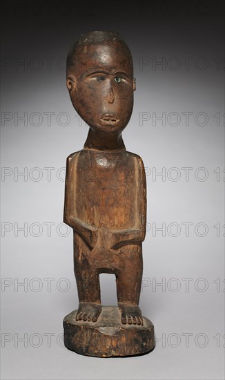 Male Figure, early 1800s. Central Africa, Democratic Republic of the Congo, Kongo  or Vili, early 19th century. Wood, iron, and glass; overall: 55.9 cm (22 in.)