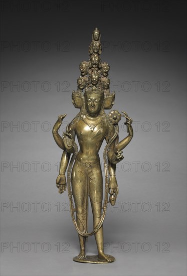 Eleven-Headed Bodhisattva of Compassion (Avalokiteshvara), around 1000. Western Himalayas. Gilt bronze with silver and copper inlay; overall: 39.4 x 14 x 7.6 cm (15 1/2 x 5 1/2 x 3 in.).