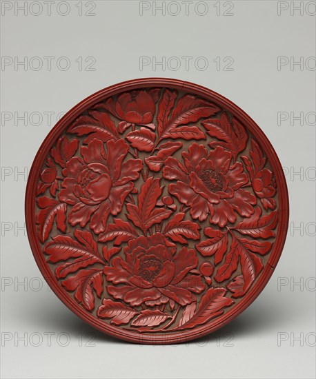 Plate with Peony Decoration, late 1300s-early 1400s. China, Yuan dynasty (1271-1368). Carved cinnabar lacquer on wood; diameter: 16.5 cm (6 1/2 in.).