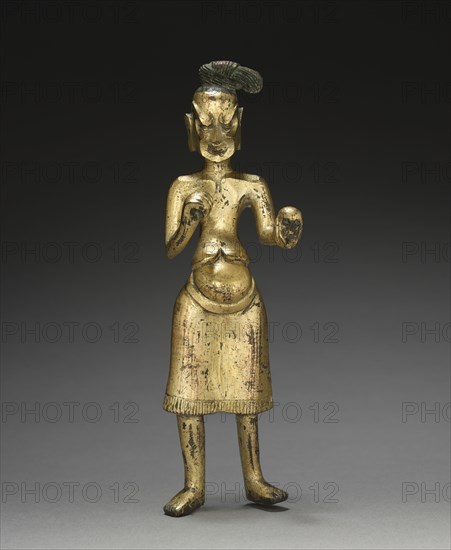 Ascetic Holding a Skull, c. 500. China, Northern Wei dynasty (386-534). Gilt bronze; overall: 19.4 cm (7 5/8 in.); figure: 18.1 cm (7 1/8 in.).