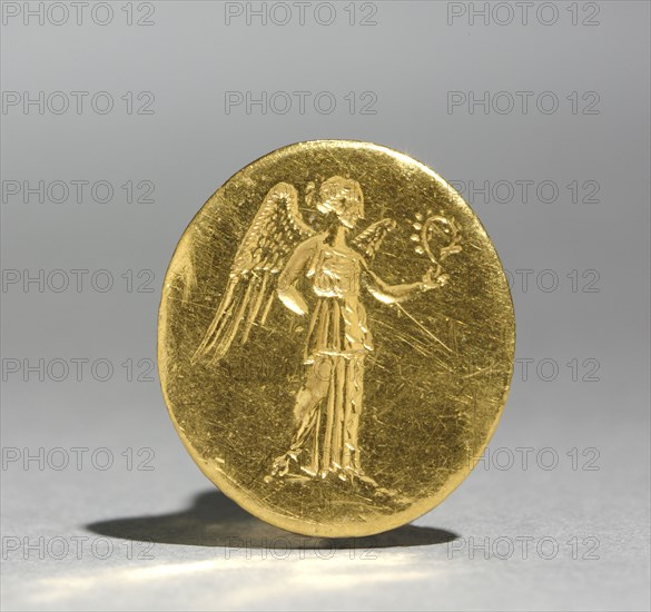 Finger Ring with Figure of Nike, 300s BC. Greece, 4th Century BC. Gold; diameter: 1.7 cm (11/16 in.); bezel: 2.2 x 2 cm (7/8 x 13/16 in.).