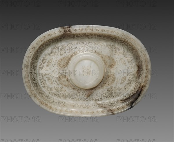 Oval Cup Stand with Animal Masks, 1736-1795. China, Qing dynasty, Qianlong mark and period (1736-1795). White jade with black markings and incised decoration; overall: 10.5 cm (4 1/8 in.).