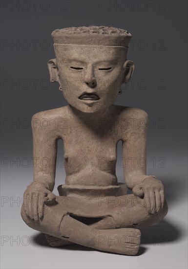 Seated Figure Wearing a Skin, 600-1000. Mexico, Gulf Coast, 7th-11th Century. Earthenware, slip; overall: 43.3 x 29.2 x 28.7 cm (17 1/16 x 11 1/2 x 11 5/16 in.).